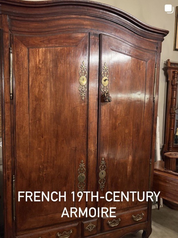 Tall French 19th-century carved-oak armoire with shaped cornice and pierced brass escutcheons.