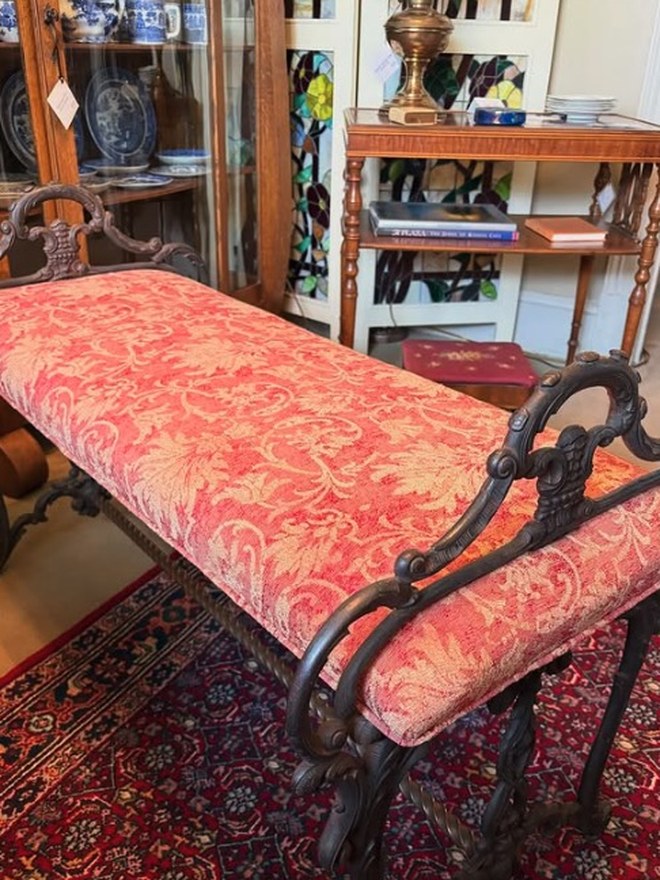 An upholstered cast-iron bench, a versatile character piece for staging