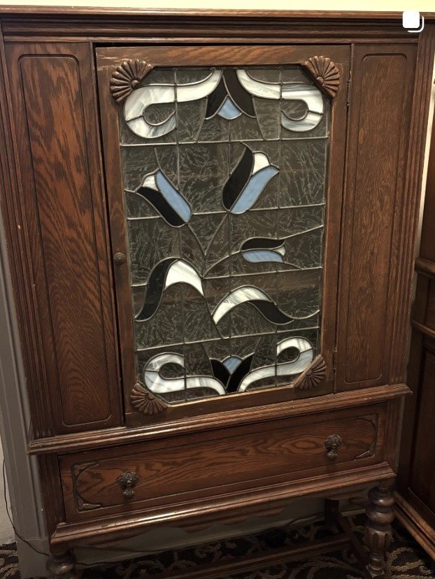 Quartersawn oak china cabinet with a leaded art-glass door in a stylized tulip pattern.