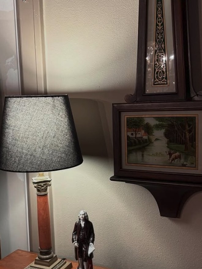 Table lamp built as a rouge-marble Corinthian column on a stepped brass base, with a black drum shade.